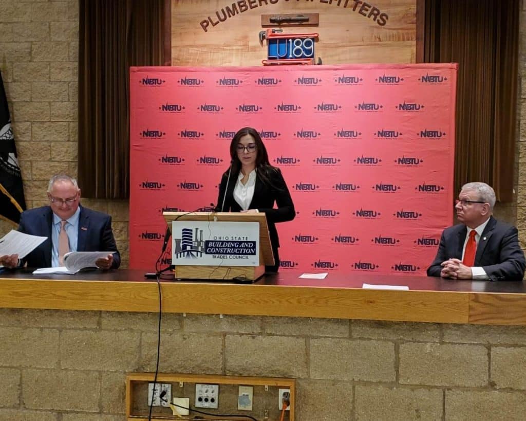 Local 24 tradeswoman McKenzie Quinn speaks at a podium during an event highlighting megaprojects and union apprenticeships.