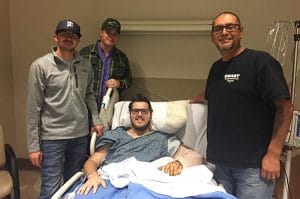 At left, Wyatt Kelly, president of Local 1117; Jason Doering, Nevada State Legislative Director, second from left; and Vince Ybarra, Local 1117 chairman, right, visit Shane Leach in the hospital in November.