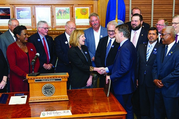 Kansas Gov. Jeff Colyer shakes hands with Tara Mays, executive director of Economic Lifelines, after signing the House Substitute for SB 391 bill creating the Joint Legislative Transportation Vision Task Force on May 16. The bearded man to Colyer’s right is Kansas State Legislative Director Ty Dragoo.