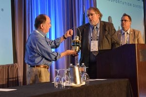 Washington state Rep. Mike Sells, left, accepts a Golden Lantern award from Washington State Legislative Director Herb Krohn at the Seattle Regional Meeting.