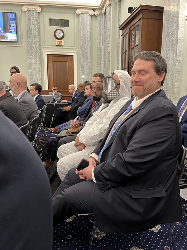 A member of the audience donned a hazmat suit while attending the U.S. Senate Commerce Committee hearing on railway safety March 22 in reference to the contamination that occurred in East Palestine, Ohio, after a Feb. 3 derailment.