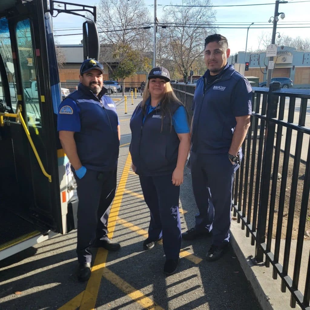 SMART Local 0023 bus drivers pose for a picture in front of a bus. 