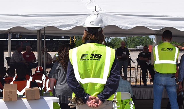 A Norfolk Southern worker at Bellevue Yard in Ohio watches a speaker during a safety town hall meeting June 1.