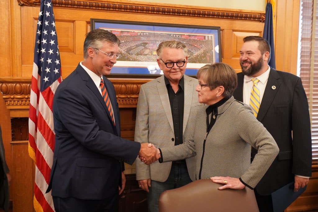 SMART Transportation Division Vice President Brent Leonard, left, shakes hands with Gov. Laura Kelly as National Legislative Director Greg Hynes and Kansas State Legislative Director Ty Dragoo, right, look on.