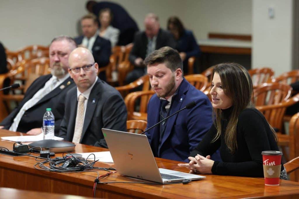 Michigan State Legislative Director Donald Roach, left, looks on during discussion of bus and transit worker protection bills by the Criminal Justice Committee of Michigan's House of Representatives.