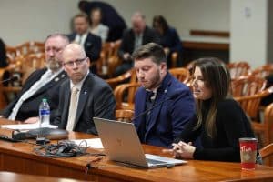 Michigan State Legislative Director Donald Roach, left, looks on during discussion of bus and transit worker protection bills by the Criminal Justice Committee of Michigan's House of Representatives.