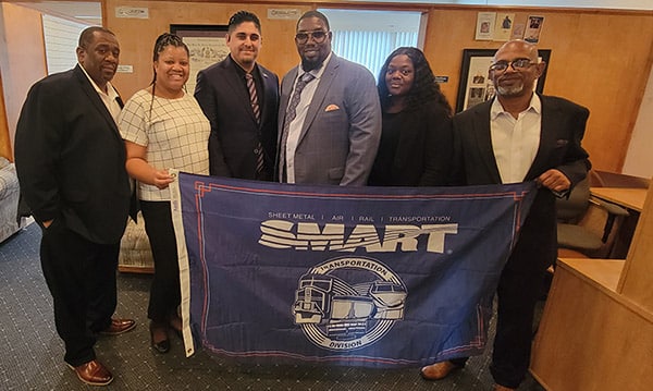 Bus Department Vice President James Sandoval and General Chairperson Anthony Petty stand with the rest of the SMART-TD negotiating team.