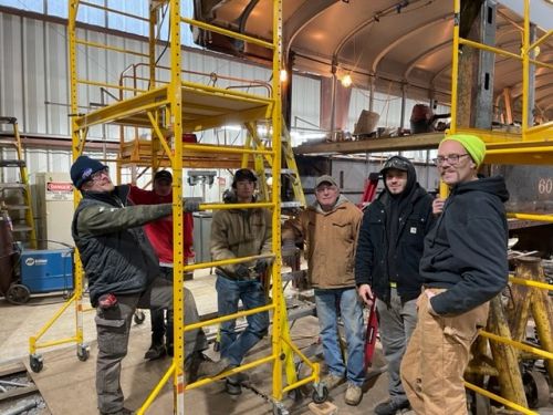 Local 46 apprentices at work restoring an old Rochester trolley car.