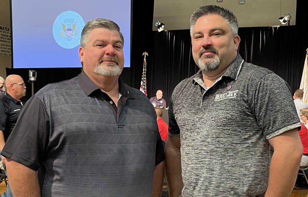 SMART-TD Kentucky State Legislative Director Jeff Mitchell, left, and Alt. National Legislative Director Jarred Cassity attend last year's NTSB hearing on the East Palestine, Ohio, derailment.